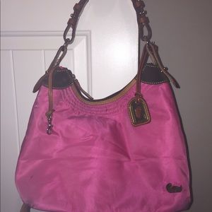 A pink Dooney & bourke shoulder bag.